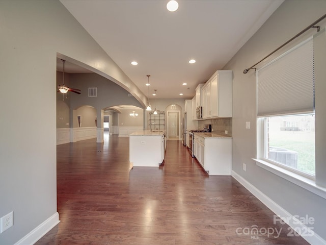 kitchen featuring sink, white cabinetry, decorative light fixtures, a center island, and appliances with stainless steel finishes