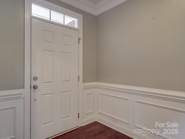 entrance foyer with ornamental molding and dark hardwood / wood-style floors