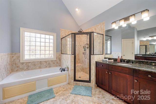 bathroom with vanity, tile patterned flooring, vaulted ceiling, and shower with separate bathtub