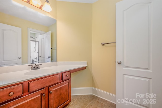 bathroom with vanity, a shower, and tile patterned floors