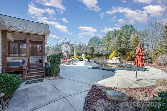 view of patio featuring a sunroom