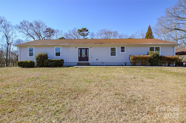 rear view of property featuring a lawn