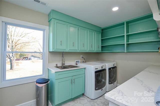 washroom featuring cabinets, separate washer and dryer, and sink