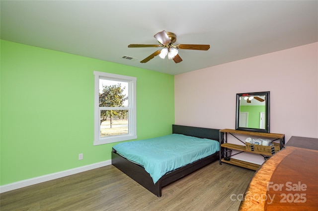 bedroom with hardwood / wood-style floors and ceiling fan