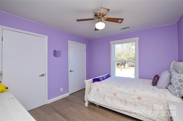 bedroom with hardwood / wood-style flooring and ceiling fan