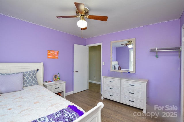 bedroom featuring ceiling fan and dark hardwood / wood-style flooring