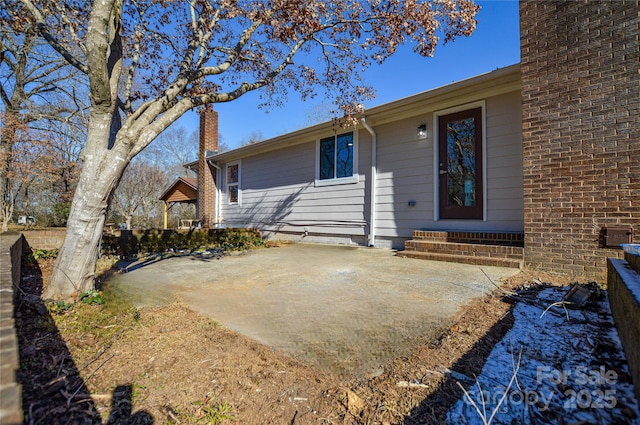 entrance to property with a patio area