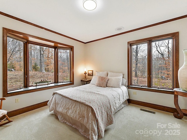 bedroom featuring crown molding and light colored carpet