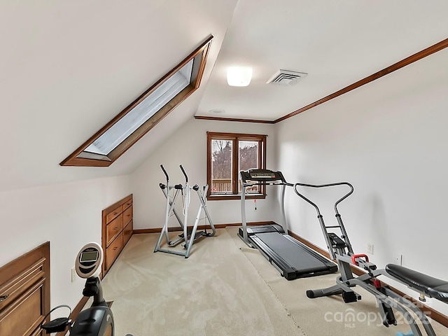 exercise room featuring lofted ceiling and light colored carpet