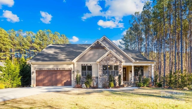 craftsman house featuring a garage and a front yard