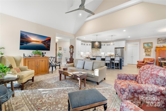 living room featuring light wood-type flooring, vaulted ceiling, and ceiling fan