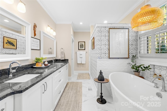 bathroom featuring tile walls, vanity, crown molding, and a bathing tub