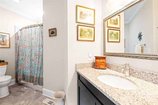 bathroom with toilet, vanity, and ornamental molding