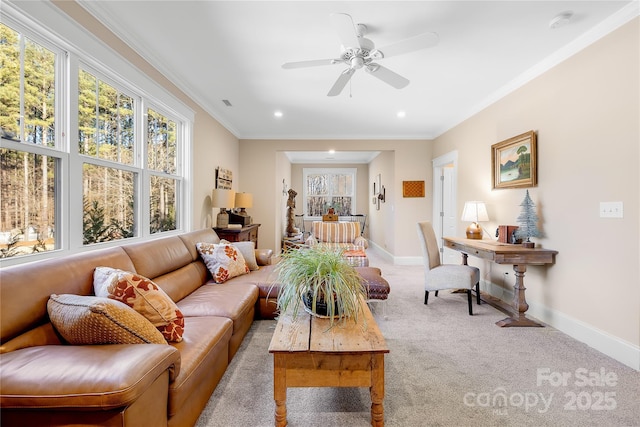 living room featuring ceiling fan, light colored carpet, and crown molding