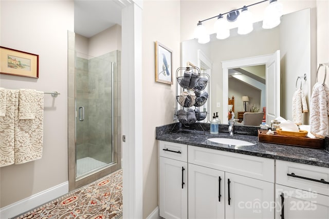 bathroom with a shower with shower door and vanity