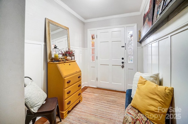 entrance foyer featuring crown molding and light hardwood / wood-style floors