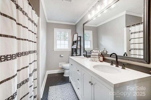 bathroom with ornamental molding, toilet, and vanity