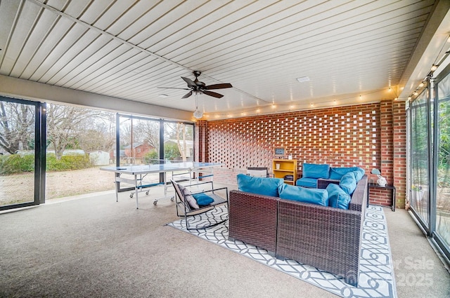 sunroom featuring ceiling fan and a healthy amount of sunlight