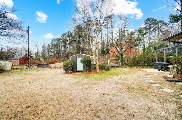 view of yard with a swimming pool, a patio area, and a shed