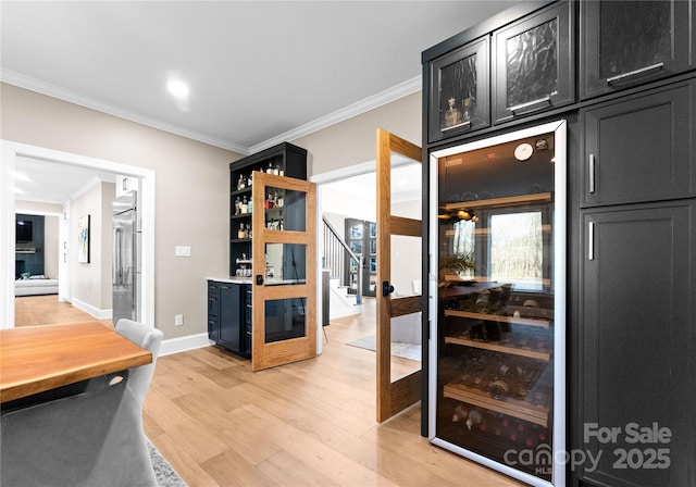 interior space featuring light hardwood / wood-style floors, crown molding, wine cooler, and built in refrigerator