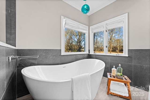 bathroom featuring a bathing tub, tile patterned floors, and tile walls