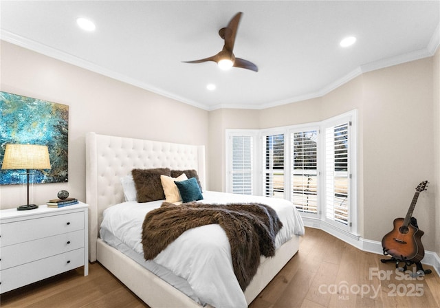 bedroom with ceiling fan, hardwood / wood-style floors, and crown molding