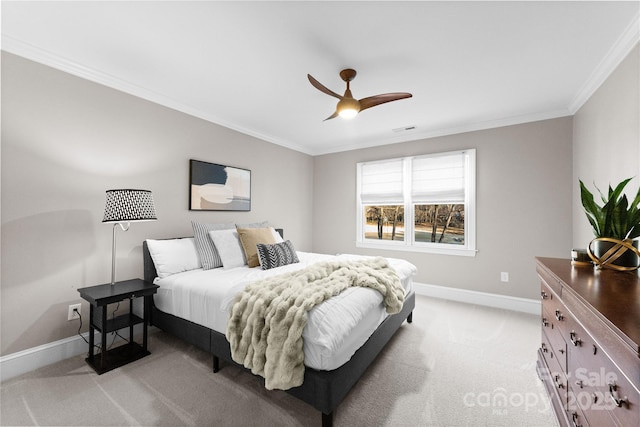 carpeted bedroom with ceiling fan and ornamental molding