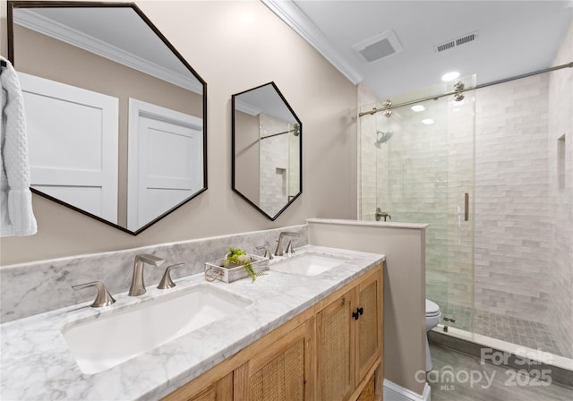 bathroom featuring vanity, a shower with shower door, crown molding, and toilet