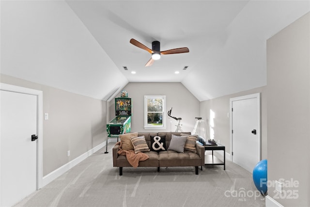 sitting room with ceiling fan, light carpet, and vaulted ceiling