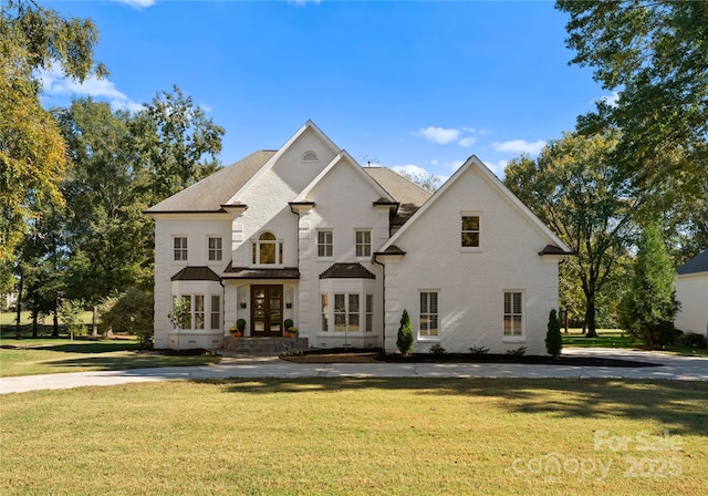 view of front of property featuring a front yard and french doors