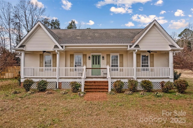 ranch-style house featuring a front lawn, ceiling fan, and covered porch