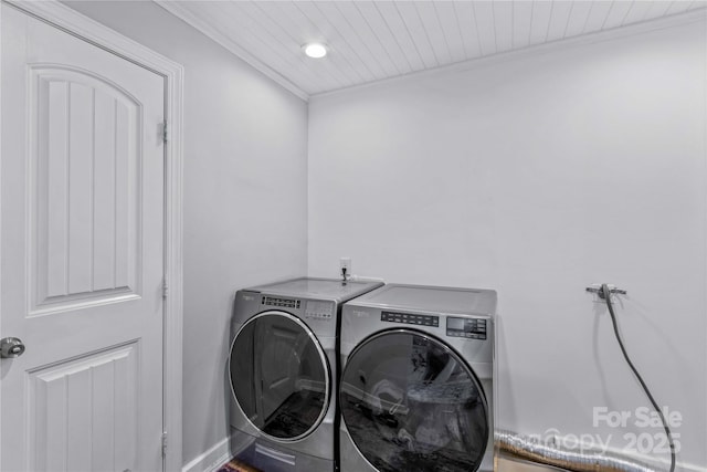 laundry area with crown molding, wood ceiling, and washer and clothes dryer