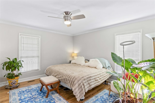 bedroom featuring crown molding, ceiling fan, and wood-type flooring