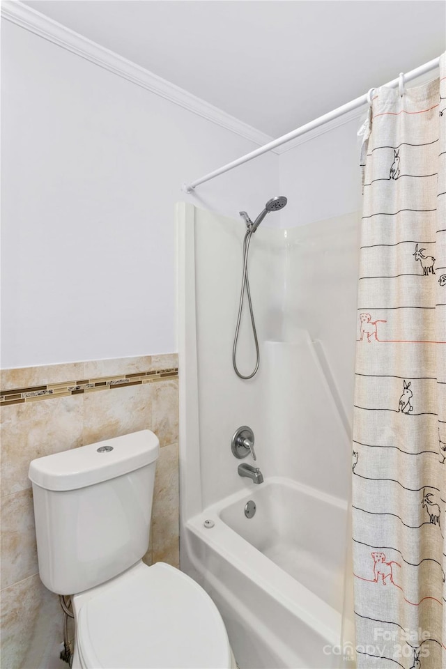 bathroom featuring shower / tub combo, ornamental molding, tile walls, and toilet