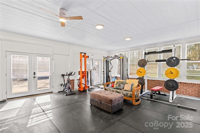 exercise room with french doors and brick wall