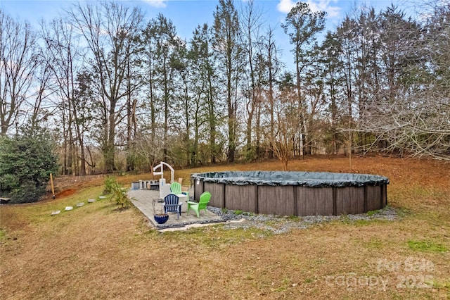 view of yard with a patio and a covered pool