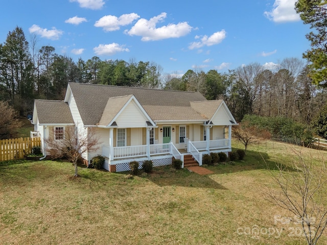 ranch-style house with a shingled roof, fence, a front lawn, and a porch