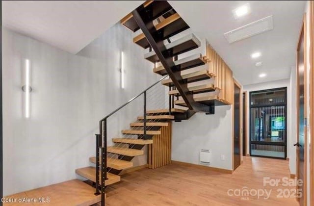 stairs with hardwood / wood-style floors