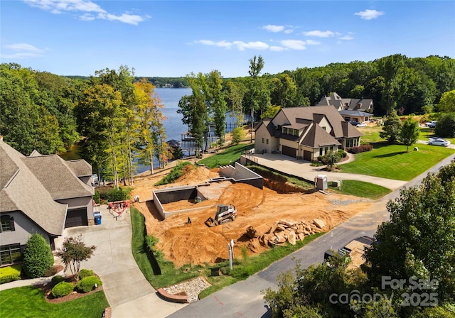 birds eye view of property with a water view