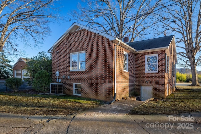 view of side of home with central AC unit