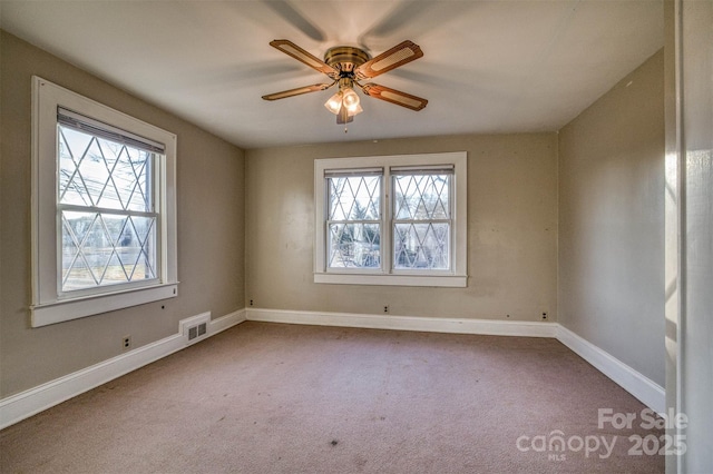 empty room with ceiling fan and carpet floors