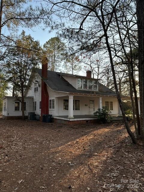 rear view of property featuring central AC unit