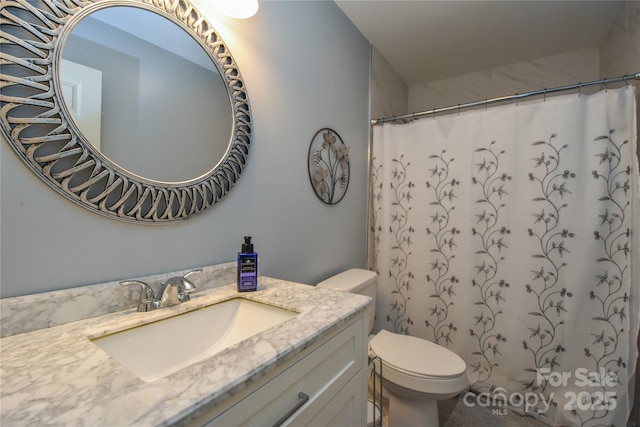 bathroom with vanity, toilet, and walk in shower