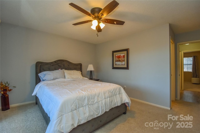 bedroom featuring ceiling fan and light carpet