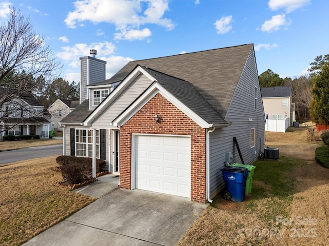 exterior space featuring central AC unit, a yard, and a garage