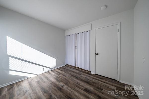 unfurnished bedroom featuring dark hardwood / wood-style floors