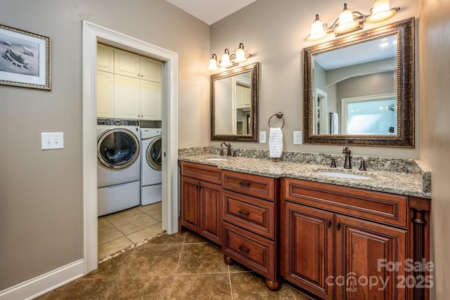 bathroom featuring tile patterned floors, vanity, and independent washer and dryer