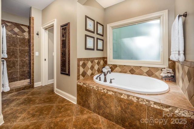 bathroom with shower with separate bathtub and tile patterned floors