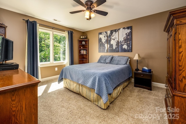 bedroom with light carpet and ceiling fan