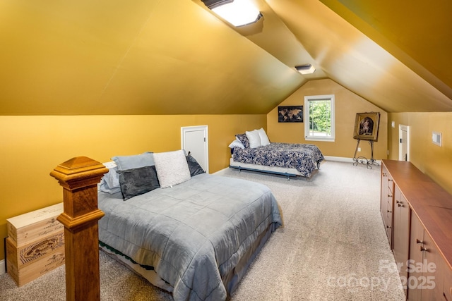 carpeted bedroom featuring lofted ceiling